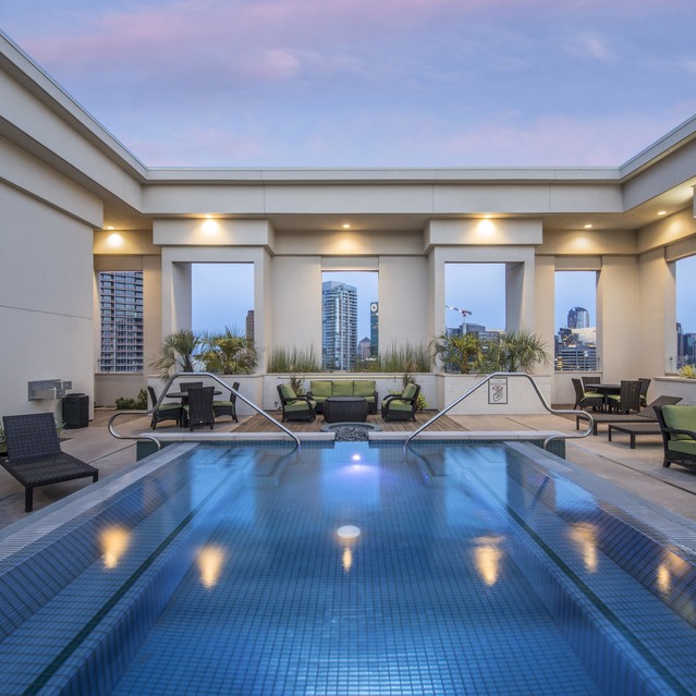The Arcadian - Rooftop Pool Surrounded by Lounge Chairs and Greenery