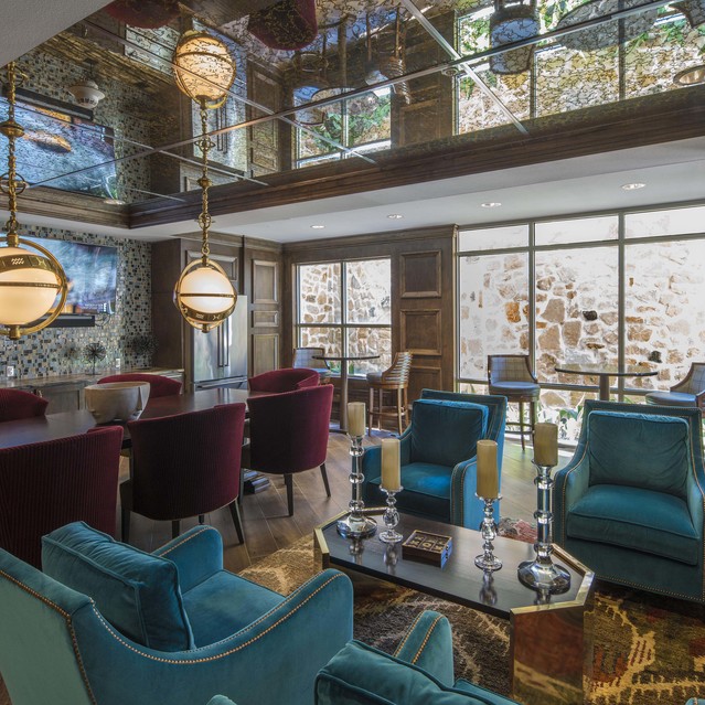 The Arcadian - Modern Lounge with Teal and Burgundy Seating and Wooden Accents