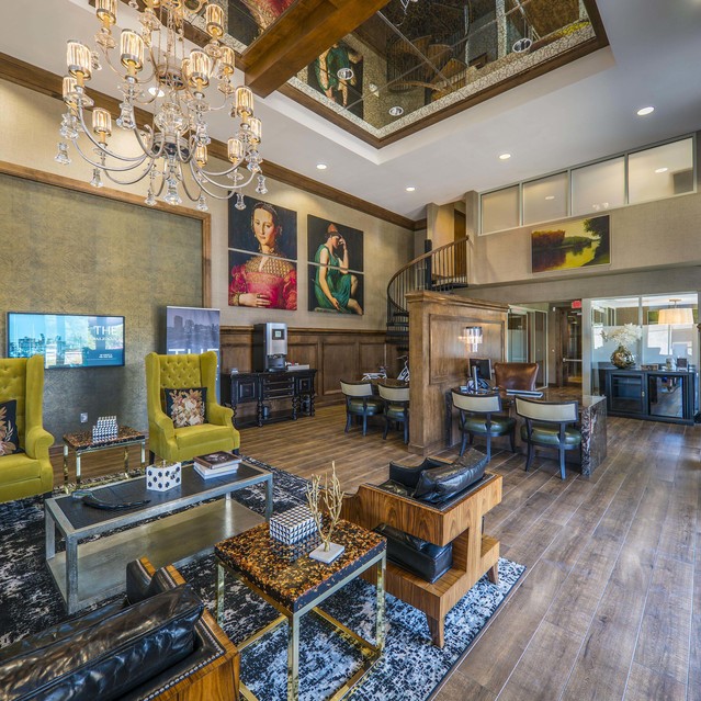 The Arcadian - Luxurious Living Room with a Chandelier and Elegant Furnishings