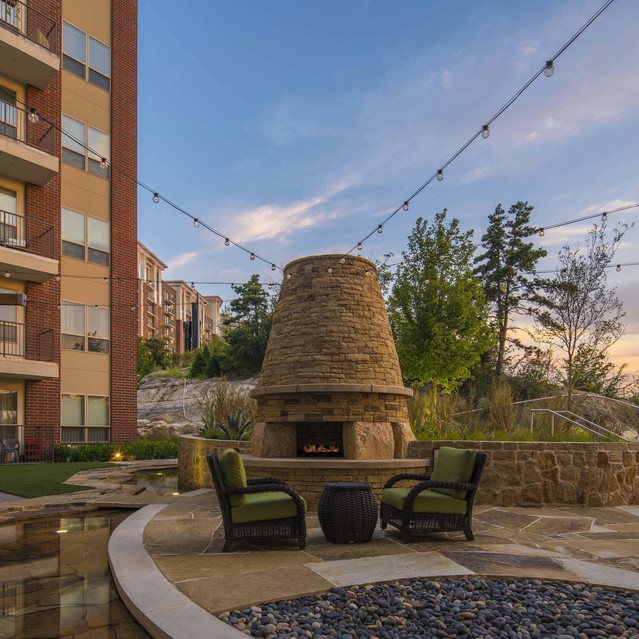 The Arcadian - Outdoor Patio With a Stone Fireplace
