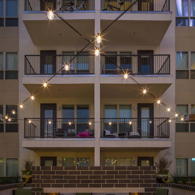 The Arcadian - Outdoor Area with a Brick Fire Pit and String Lights