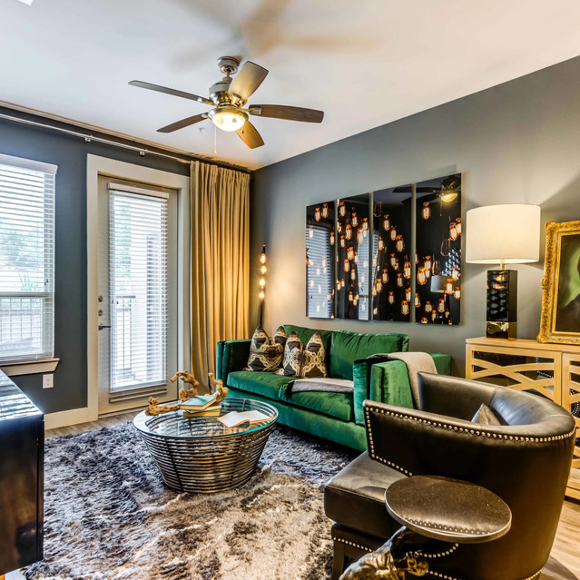 The Arcadian - Stylish Living Room with a Green Sofa, a Round Coffee Table, and Elegant Décor